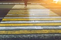 A person crosses the road at a pedestrian crossing, the car passes a pedestrian passing through a Zebra crossing Royalty Free Stock Photo