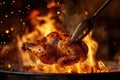 A person is currently cooking a chicken over a blazing fire using a fork Royalty Free Stock Photo