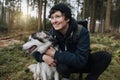 Person hugs his dog in the forest