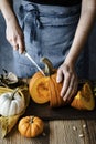 Person cutting Halloween pumpkin closeup