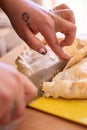 person cutting a meat tart in half