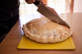 person cutting a meat tart