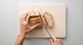 Hands Cutting Sandwich on White Board Royalty Free Stock Photo
