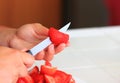 Person cutting strawberries with a knife