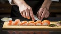 Person Cutting Sushi on Cutting Board, Step-by-Step Guide to Making Sushi at Home Royalty Free Stock Photo