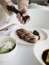 a person cutting up a piece of food on a plate Royalty Free Stock Photo