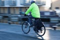 Person cycling with safety clothing and helmet