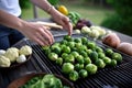 person delicately arranging brussel sprouts for grilling