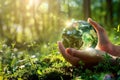 A person delicately cradles a small green earth in their hands, symbolizing care, protection, and hope for our planets Royalty Free Stock Photo