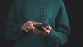 Person dialing on a smartphone with a futuristic virtual keypad interface hovering, symbolizing advanced communication.