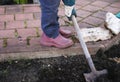 Person diggin ground in a garden. Agriculture consept.