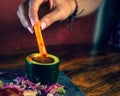 Person dipping a carrot stick in soy sauce