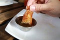 Person dipping Shrimp Spring Roll into sauce