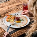 Person dipping Vietnamese Shrimp Spring Roll into sauce in restaurant Royalty Free Stock Photo