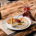 Person dipping Vietnamese Shrimp Spring Roll into sauce in restaurant Royalty Free Stock Photo