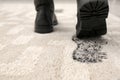 Person in dirty shoes leaving muddy footprints Royalty Free Stock Photo