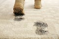 Person in dirty shoes leaving muddy footprints Royalty Free Stock Photo