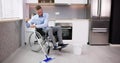 Person With Disabilty Cleaning Kitchen Floor Royalty Free Stock Photo