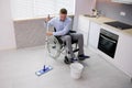 Person With Disabilty Cleaning Kitchen Floor Royalty Free Stock Photo