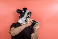 Person disguised as a cow playing a video game