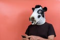 Person disguised as a cow using a cell phone