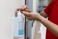 Person dispensing disinfectant sanitizer liquid onto hand in hos Royalty Free Stock Photo