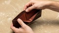 Empty brown leather wallet held open, showing financial hardship and poverty Royalty Free Stock Photo