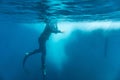 Person diving in dark night water with his head on dry land