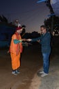 The person donates rice and money to the beggar before dawn in Sijohora Madhya Pradesh India. Royalty Free Stock Photo