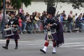 Person dressed in traditional Scottish dress marching for the national day of 14 July , France
