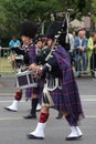 Person dressed in traditional Scottish dress marching for the national day of 14 July , France