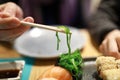 Person eating chukka seaweed with chopsticks