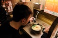 Person eating Ichiran Ramen resturant at Osaka, Japan