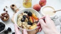 Person eating oatmeal porridge, healthy breakfast