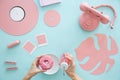 Person eating pink doughnut