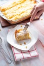 Person eating tasty pie cheese and raisins at the table Royalty Free Stock Photo