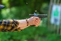 Person practicing shooting at an outdoor range with a handgun during daylight Royalty Free Stock Photo