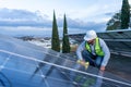 person engineer cleaning the dust dust from a solar panel technician giving maintenance to a renewable energy station cleansing Royalty Free Stock Photo