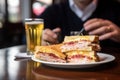 person enjoying monte cristo sandwich at a cafe