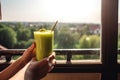 person, enjoying smoothie or shake on hot day, with view of sunny outdoor scene