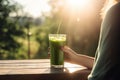 person, enjoying smoothie or shake on hot day, with view of sunny outdoor scene