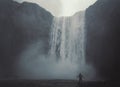 Person enjoys waterfall landscape photo