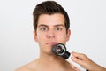 Person Examining Man Face With Dermatoscope Royalty Free Stock Photo