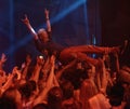 Person, excited and crowd surf at concert, live show and performance for heavy metal band at night. Happy, devil horns
