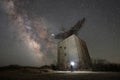 A person exploring an abandoned military base coming across a radar tower at night under the Milky Way Galaxy Royalty Free Stock Photo