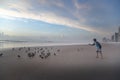 Person feeding the pigeons on the beach in New Orleans