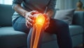 Person feels sharp knee pain, joint problem. Arthritis and tendon issues visualized with glowing orange joint area. Focus on pain Royalty Free Stock Photo
