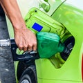 Person filling gas into a car station Royalty Free Stock Photo