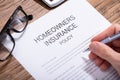 Person Filling Homeowners Insurance Policy Form