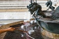 Person filling up ladle with water of chozuya fountain Royalty Free Stock Photo